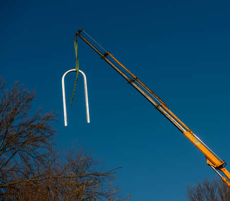 Unloading goods from the truck with a craneの写真素材