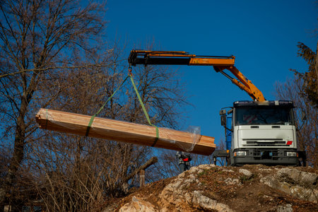 Unloading goods from the truck with a craneの写真素材