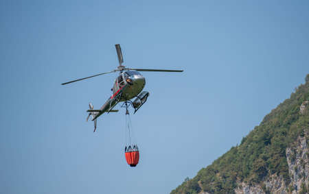 Bergamo Italy 20 July 2022: Helicopter used to transport water to put out firesの写真素材