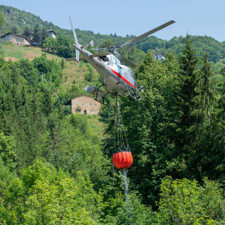 Bergamo Italy 20 July 2022: Helicopter used to transport water to put out firesの写真素材