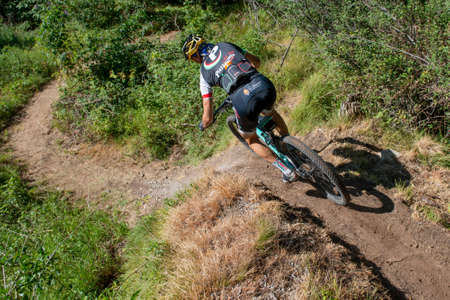 Rovetta Italy 31 July 2022: Cyclists traveling on challenging trails on mountain bikesの写真素材