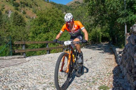 Rovetta Italy 31 July 2022: Cyclists traveling on challenging trails on mountain bikesの写真素材