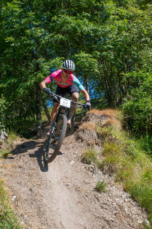 Rovetta Italy 31 July 2022: Cyclists traveling on challenging trails on mountain bikesの写真素材