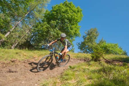 Rovetta Italy 31 July 2022: Cyclists traveling on challenging trails on mountain bikesの写真素材