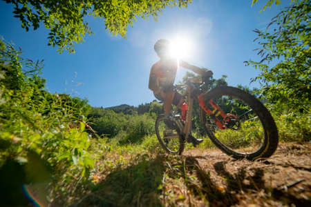 Rovetta Italy 31 July 2022: Cyclists traveling on challenging trails on mountain bikesの写真素材