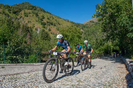 Rovetta Italy 31 July 2022: Cyclists traveling on challenging trails on mountain bikesの写真素材