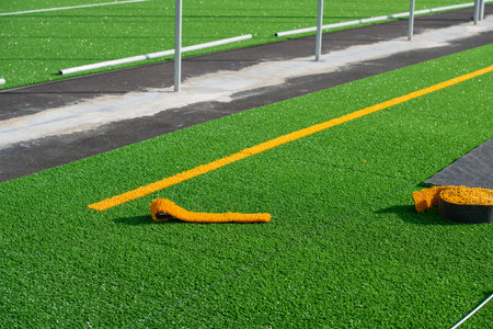 Laying of synthetic grass in a sports centerの写真素材