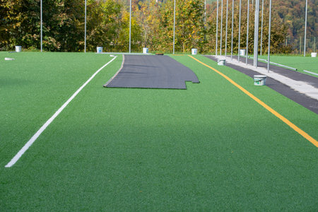 Laying of synthetic grass in a sports centerの写真素材