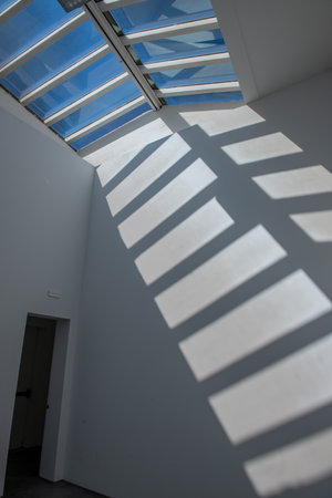 Room illuminated by the light entering through the skylightの写真素材