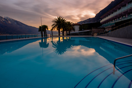 Deserted swimming pool in the evening at sunsetの写真素材