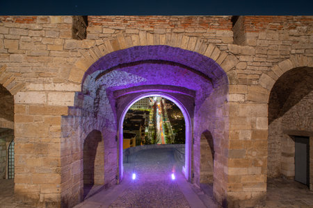 Porta San Giacomo illuminated with the background of the city of Bergamoのeditorial素材