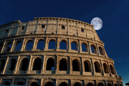 Colosseum in rome at sunset with moonの写真素材