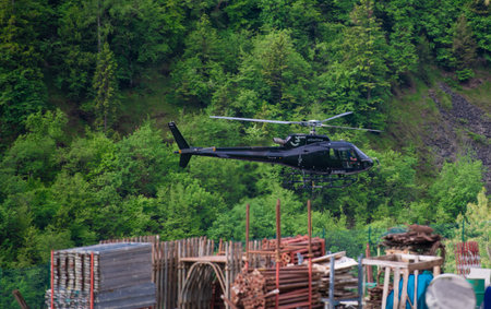 Zorzone Italy June 5 2023: Helicopter for the transport of building materials in the mountainsの写真素材
