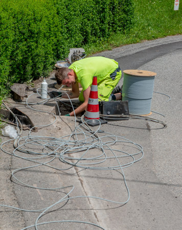 Bergamo Italy May 25th 2023: Workers who are laying the cables for the connection of the optical fiberの写真素材