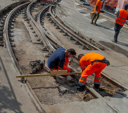 Milan Italy July 19th 2023:Workers at work while sistenabo the tram railsのeditorial素材
