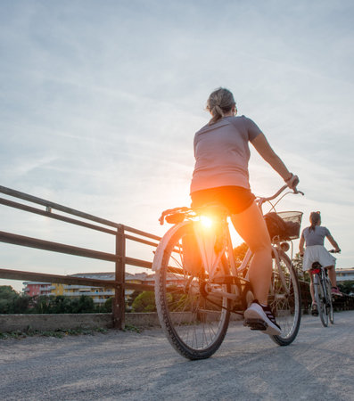 Cycling on the bike path at sunsetの写真素材