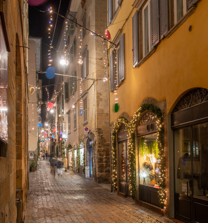 Ancient city street illuminated with Christmas decorationsの写真素材