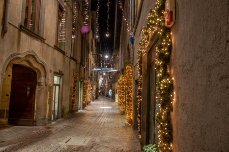 Ancient city street illuminated with Christmas decorationsの写真素材