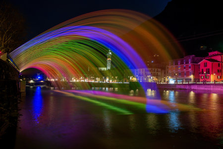 Illuminated water jets in rainbow colorsの写真素材