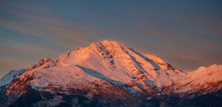 Snow-capped Monte Arera illuminated at sunsetの写真素材