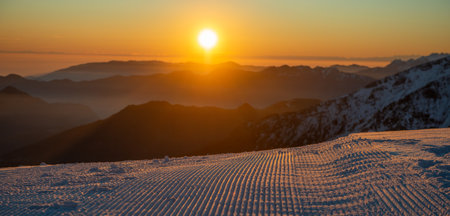 Freshly groomed ski slope at sunsetの写真素材