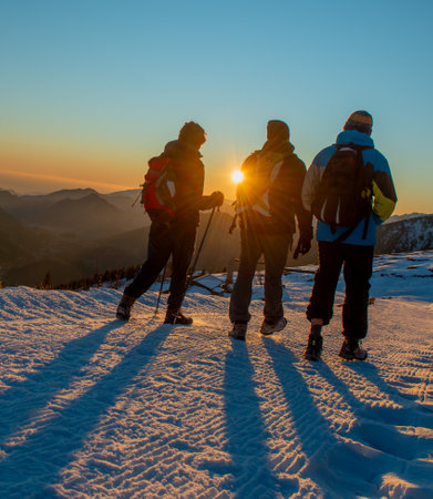 Sunset walk in the mountains with snowの写真素材