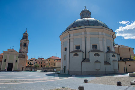 Central square of Loano with the cathedral of San Giovanni Battistaの写真素材