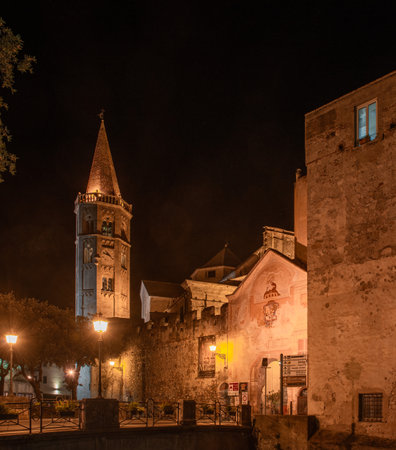 External facade of Porta Reale and the ancient walls with the bell tower of the Church of San Biagio di Finalborgoの写真素材
