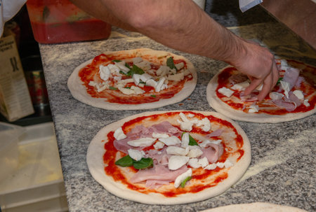 Preparing the pizza before putting it in the ovenの写真素材