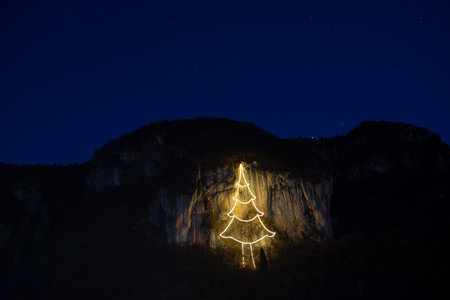 Cornalba cliff illuminated with Christmas treeの写真素材