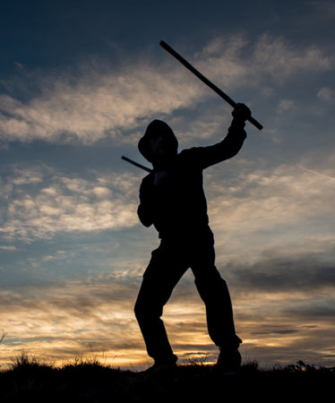 Training with poles at sunset on the top of the mountainの写真素材
