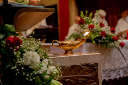 Candle on the altar in a Catholic church during a religious ceremonyの写真素材