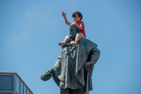 Bergamo Italy June 28, 2025: Statue of Giuseppe Garibaldi in Piazza dei Mille in Bergamo with a plastic mannequin sitting on the shoulders of the statueの写真素材