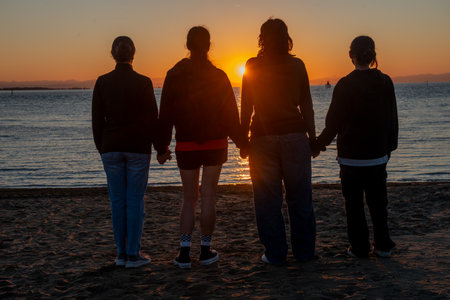 Group of friends at dawn waiting for the sun to rise