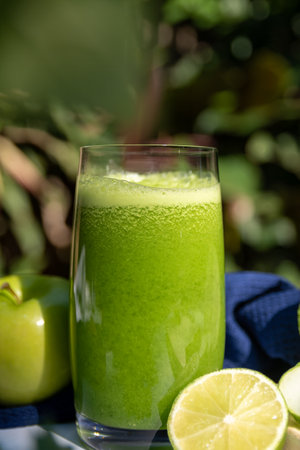 Healthy green smoothie in a glass with apple and lime.の写真素材