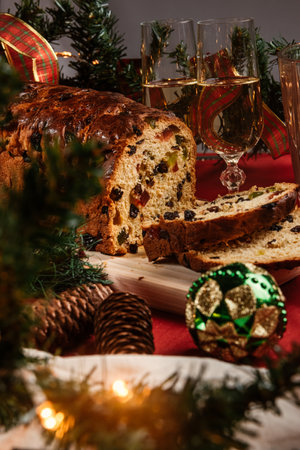 Christmas cake with raisins, dried fruits and a glass of champagneの写真素材