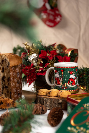 Cup of chocolate with a panettone, cookies and Christmas decorations on a white backgroundの写真素材