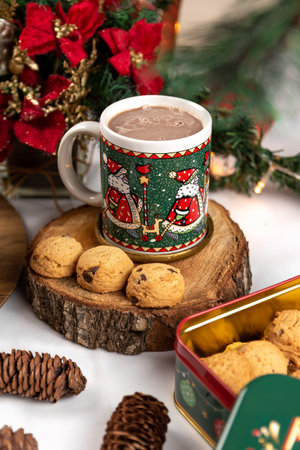 Cup of hot chocolate and cookies on a wooden background with Christmas decorationsの写真素材