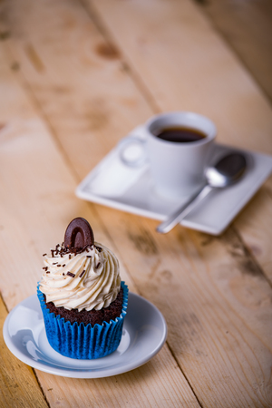 breakfast whit cupcake and coffee on the wooden backgroundの写真素材