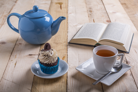 break study whit tea and cupcake on the tableの写真素材