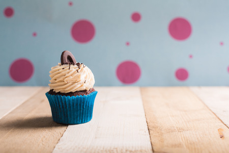 cupcake whit buttercream and chocolate on the tableの写真素材