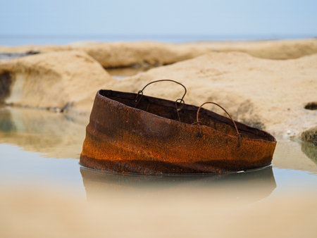 rusty barrel in waterの写真素材