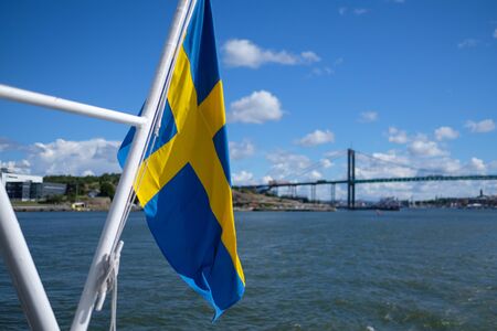 swedish flag with bridge in background