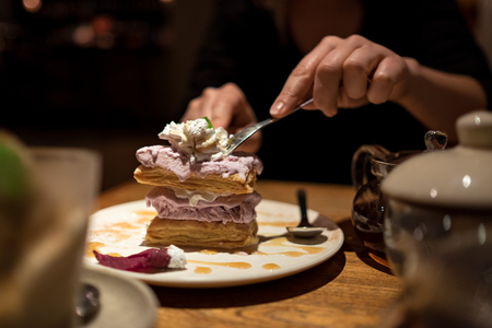 Girl eating ice in cafeの写真素材