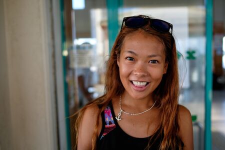 Kohama, Japan - November 23: Unidentified cute girl smiles at the camera on November 23, 2015 in Kohama, Japan. Kohama is part of the Yaeyama islands in the south of Japanのeditorial素材