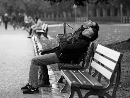 Frankfurt, Gemany - October 24: Unidentified men sleep on bench at the lake on October 24, 2015 in Frankfurt, Germany.のeditorial素材