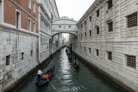 Venice, Italy: October 04: Gondolas with tourists ride below famous Ponte dei Sospiri on October 04 in Venice, Italy.のeditorial素材
