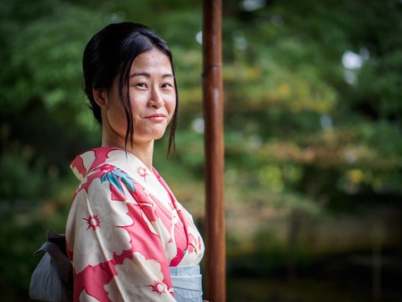 Kyoto, Japan - October 03: Unidentified female tourist in tradional Japanese clothes smiles in Shoren-In temple on October 03, 2015 in Kyoto, Japan.のeditorial素材