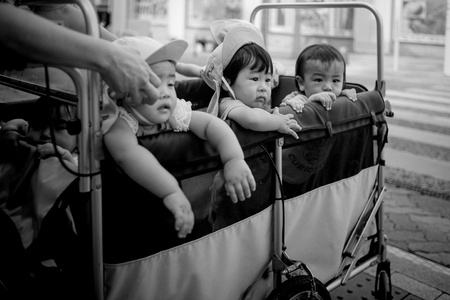 Naha, Japan - November 16: A wagon full of unidentified kids on the streets on November 16, 2015 in...
