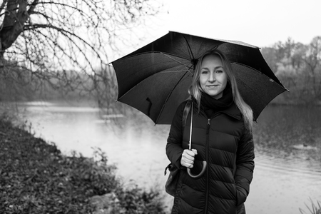 Blonde girl with umbrella in Kranichstein, Germanyの写真素材